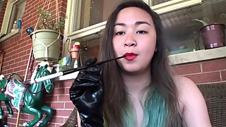 Asian retro smoking with gloves and cigarette holder